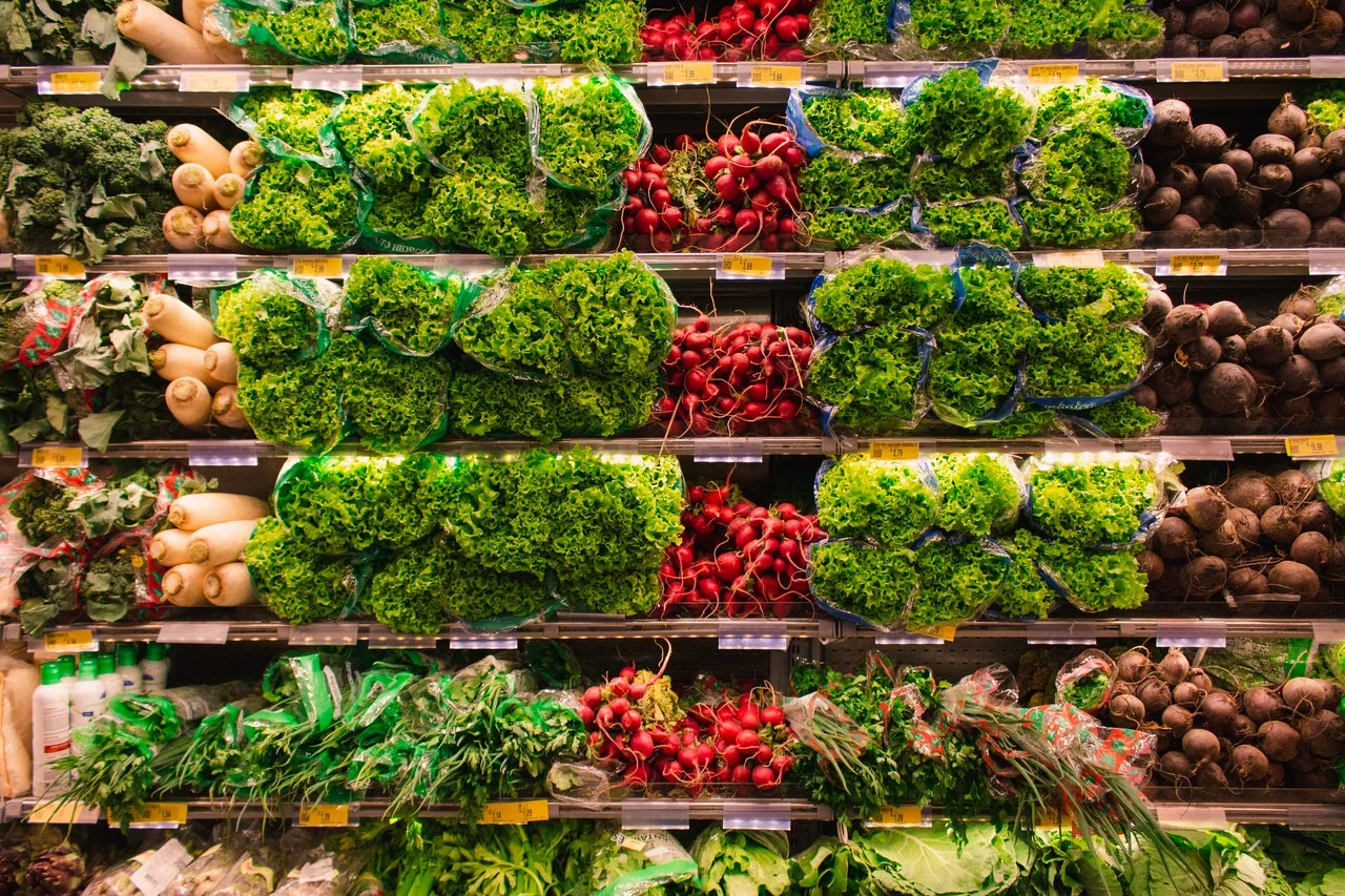 Fresh vegetables on a grocery aisle.