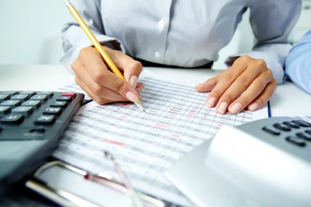 Accountant writing on paper.